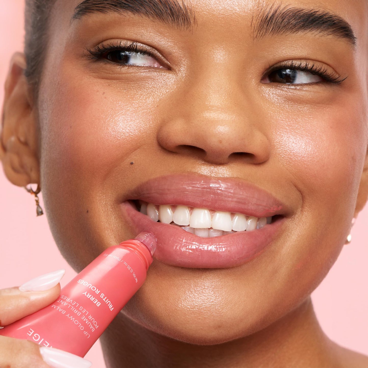 LANEIGE Lip Glowy Balm with shea butter provides sheer tint and hydration for soft, shiny lips.